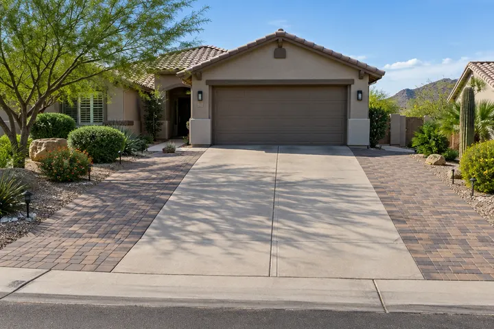 Driveway widened with pavers on both sides of an existing concrete driveway in front of a Phoenix home